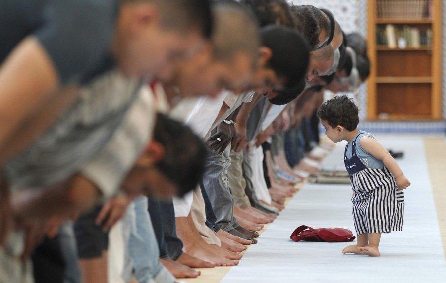 boy watching people pray